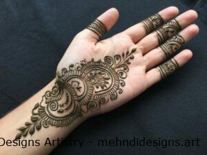 Intricate henna design on palm and fingers