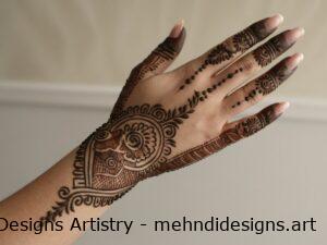 Intricate mehndi on back of hand with florals and paisleys